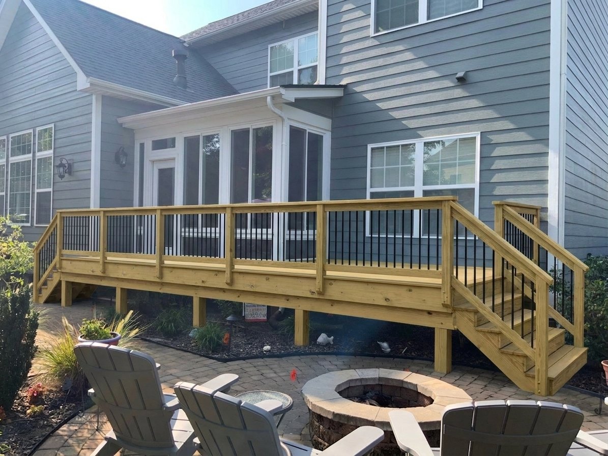 Customer-generated DeckDraft AI visualization of a wood deck with black balusters and stairs down to a paver patio beside a gray house